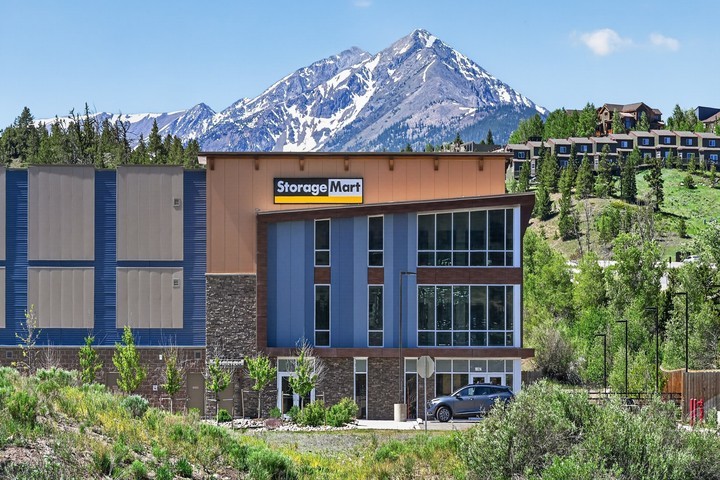 Front view of facility exterior with mountain range in the background at StorageMart in Silverthorne Colorado