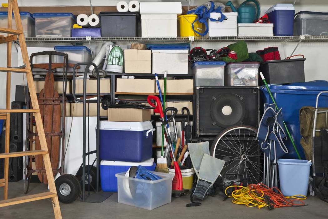 A stack of boxes and bins in storage