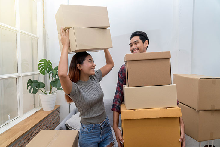 Young couple packing boxes to put into self storage.