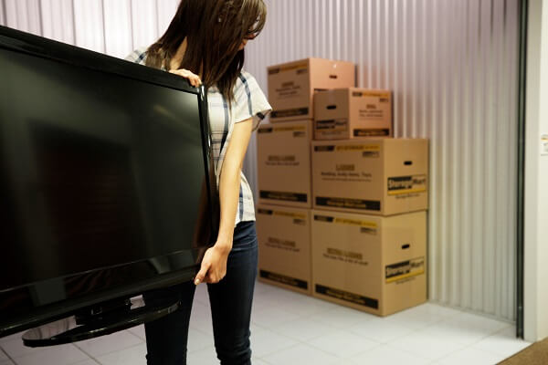boxes and a TV in a self storage unit