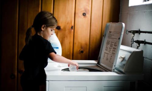 Little girl helping at drying machine