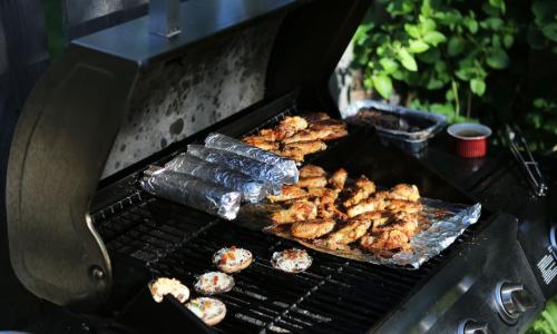 Food cooking over an open gas grill