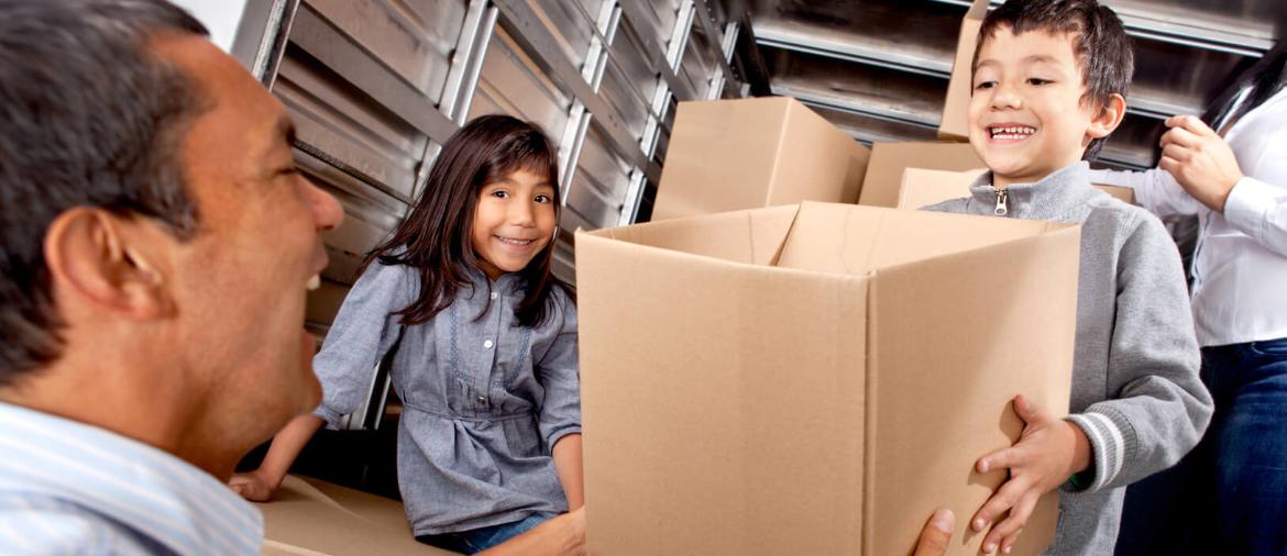 Family packing a moving truck