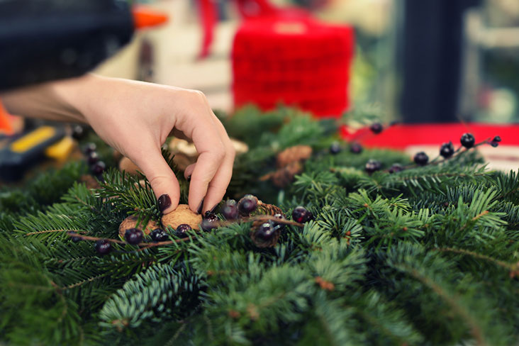 A woman prepares holiday decorations for self storage