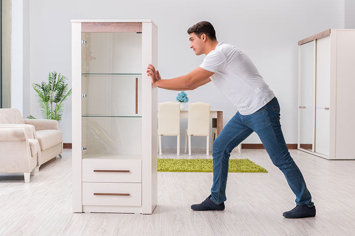 Man prepares to move a dresser to a self storage unit