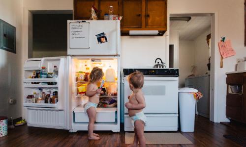 Kids at the refrigerator at a home