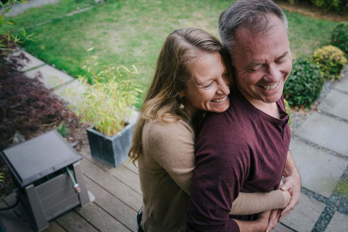 A man and woman hugging and laughing