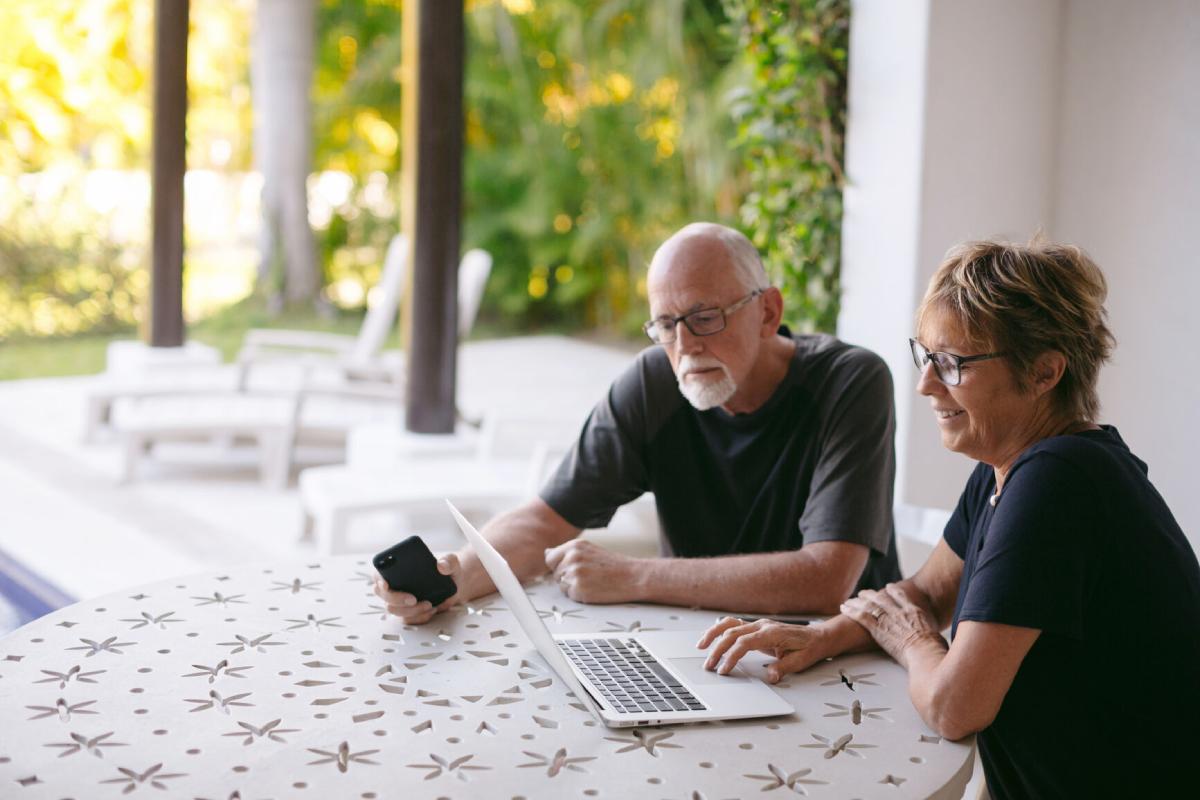 A Man and Woman looking at a laptop