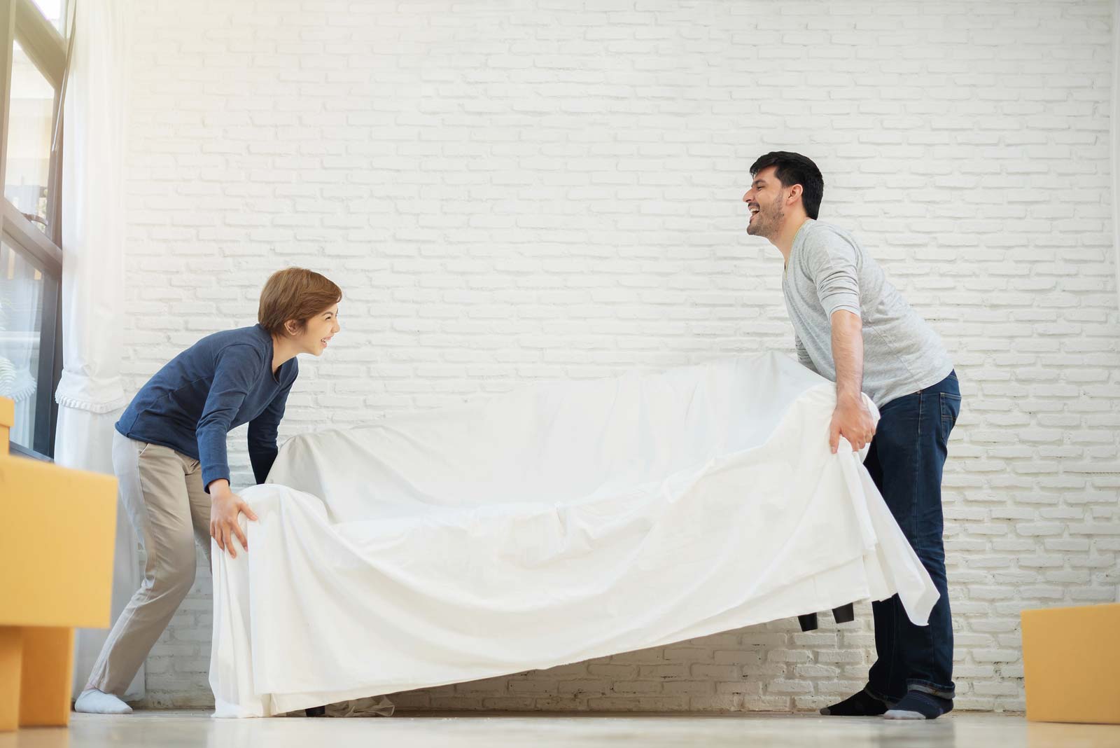 Man and boy move couch into self storage unit