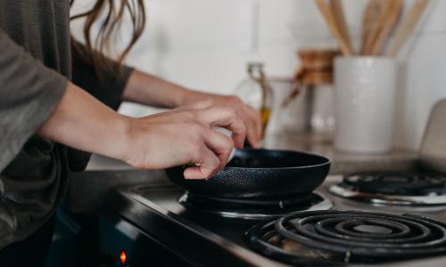 Woman at stove in home